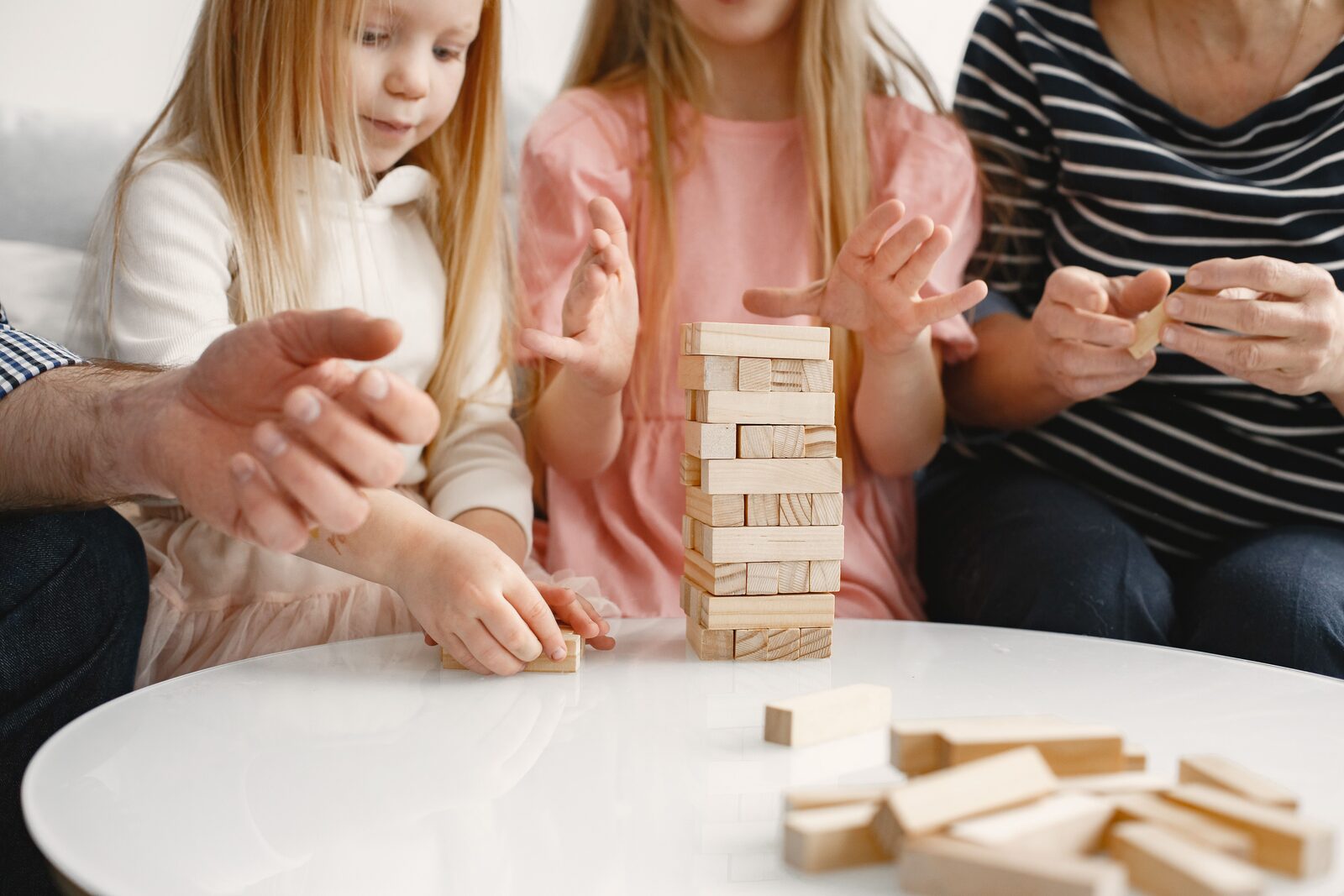 The kids playing wooden blocks at the table