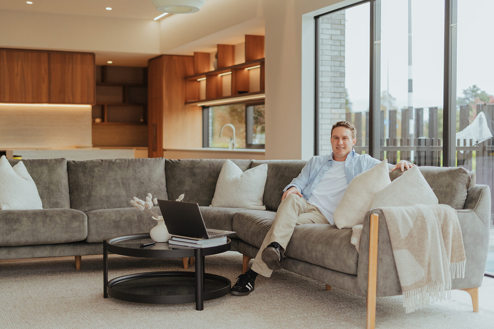 Jonathan sitting on a couch in a modern living room