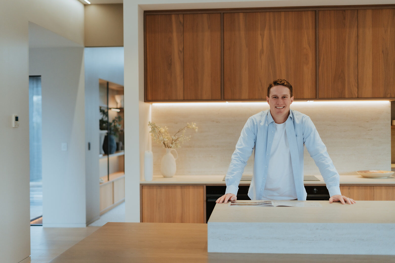 Jonathan standing at the kitchen bench of a newly built home