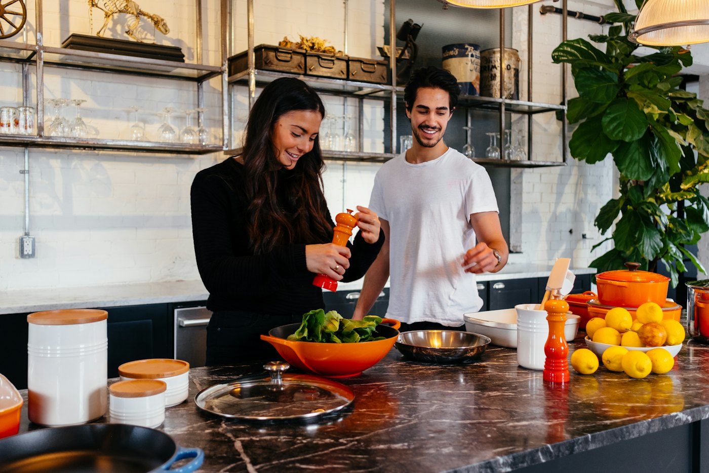 Two people at home working through their finances at the kitchen table