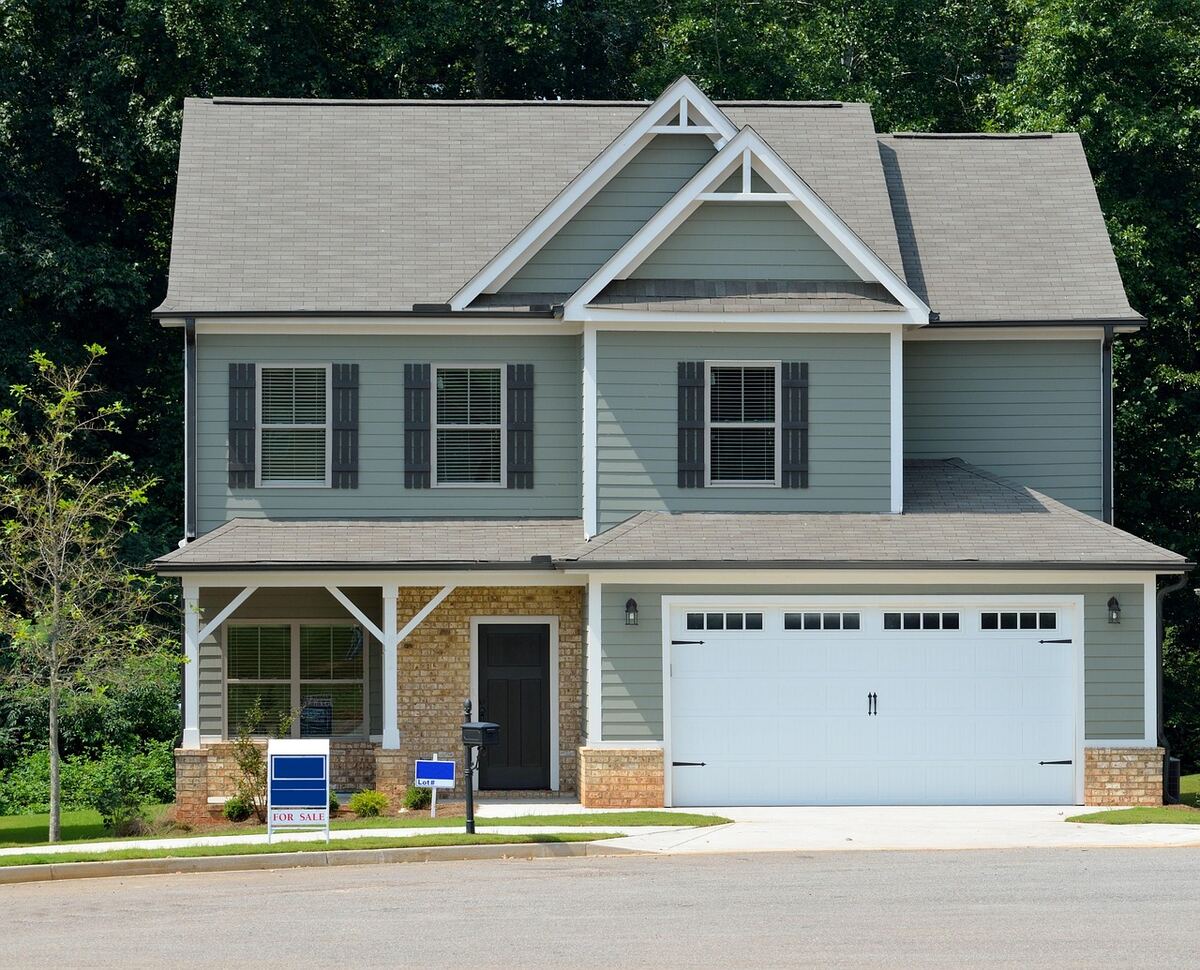 House with a for sale sign out front